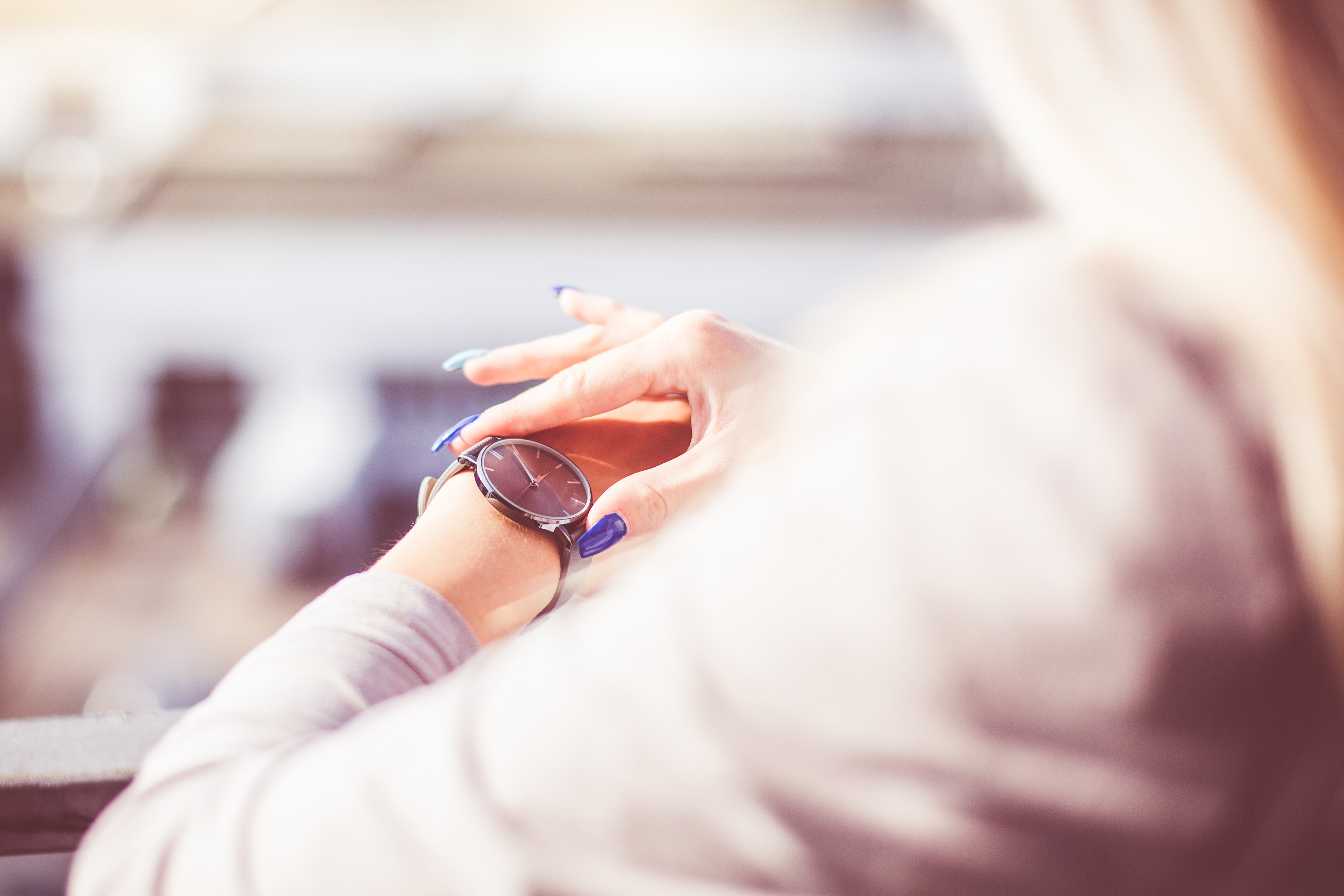 Close up of a woman checking her watch to represent how to get Visibly Fit™ time management with Wendie Pett, ND.